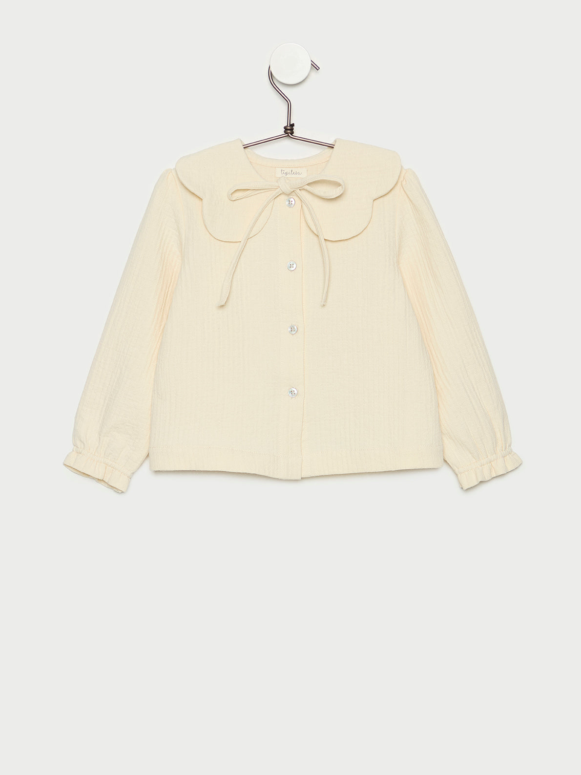 Blusa de niña crudo con cuello y lazo